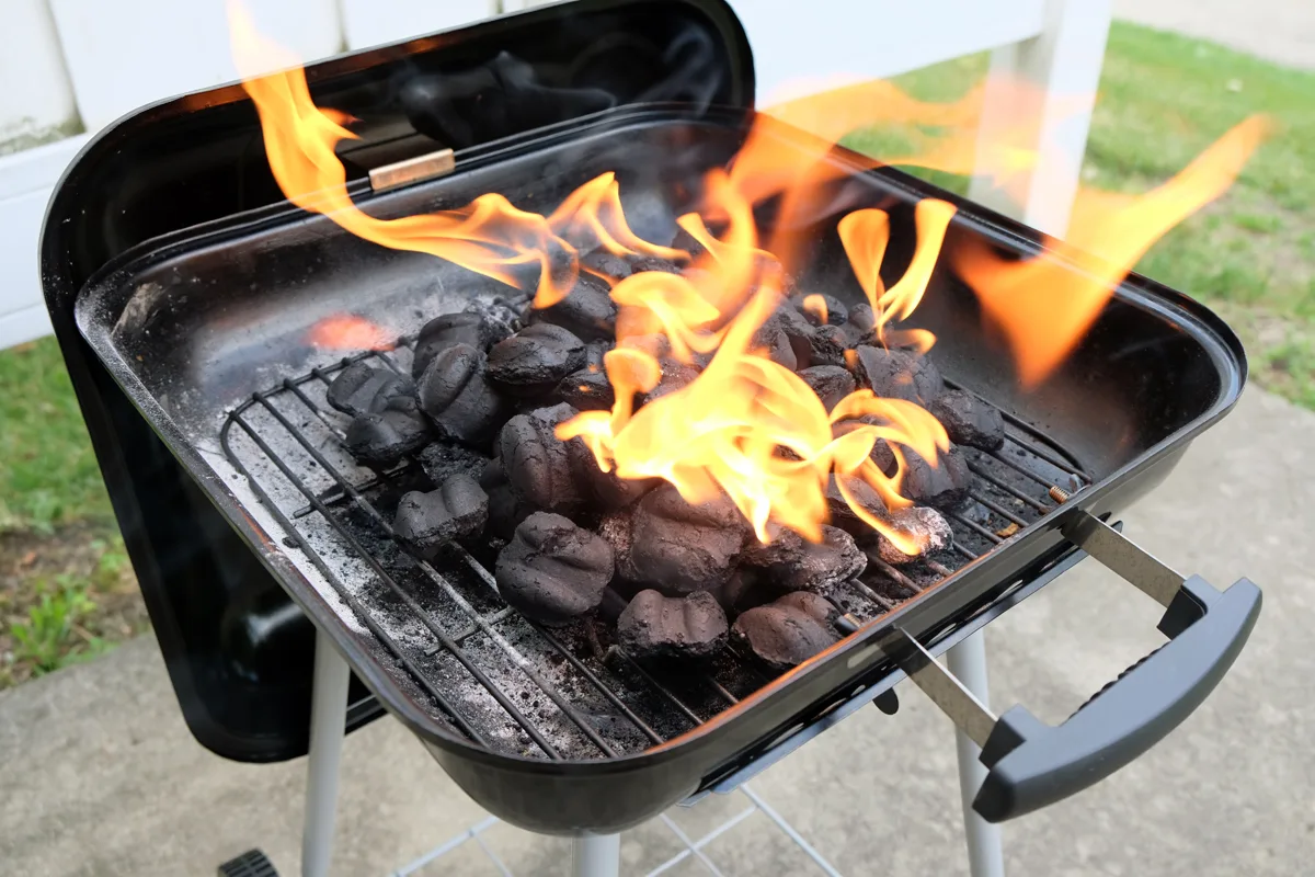 Charcoal briquettes firing up for the grill