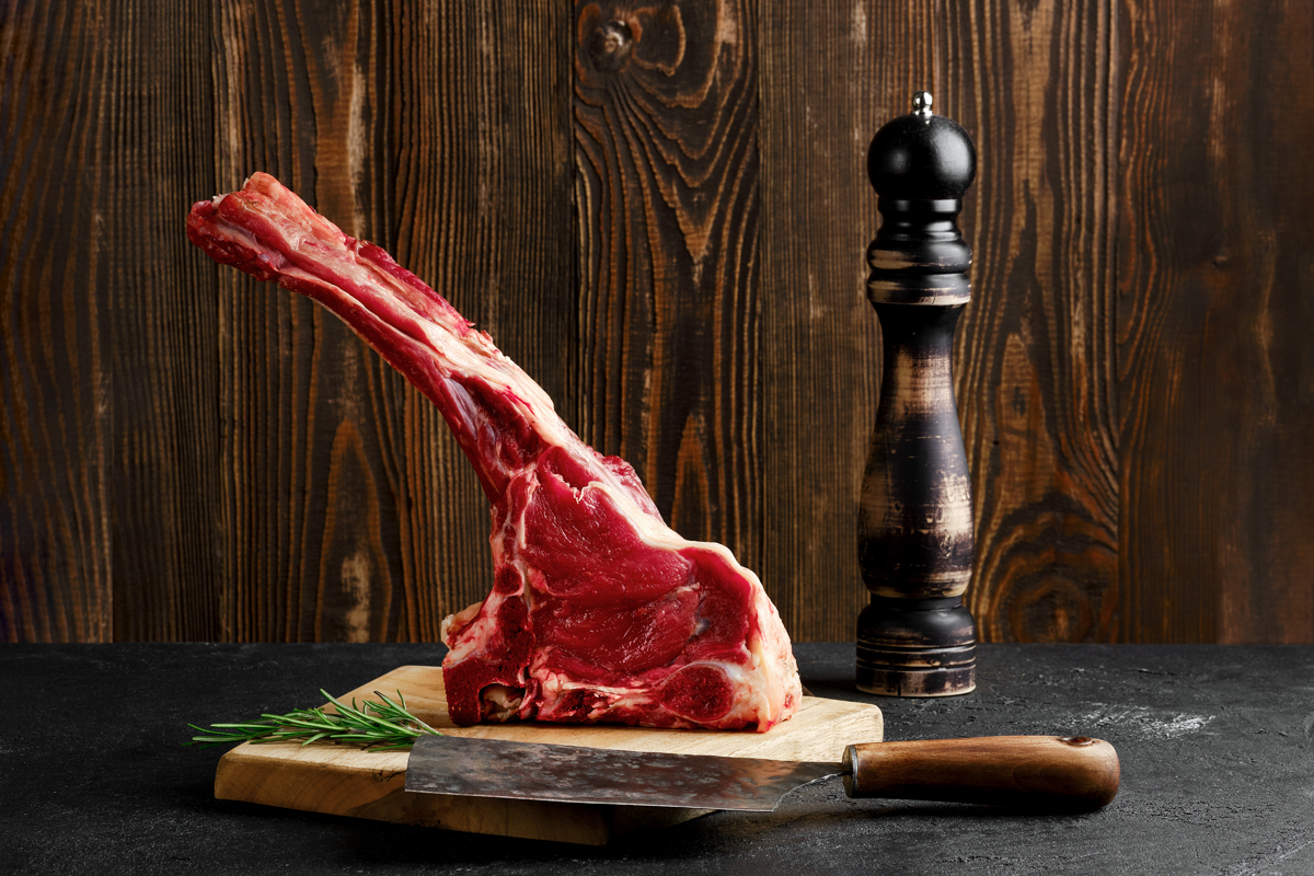 Raw Prime Ribeye Steak On Cutting Board