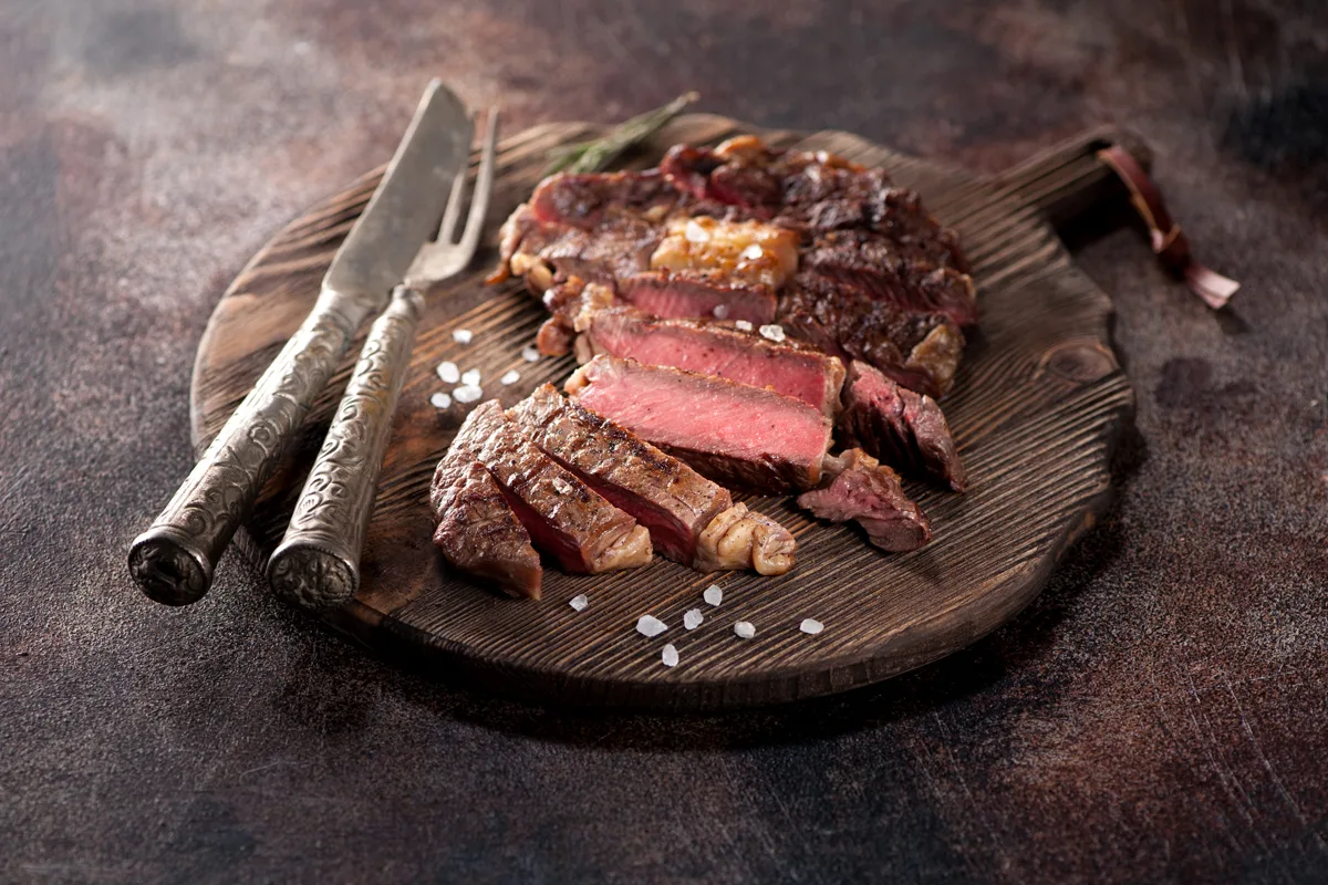 Medium Rare Grilled Beef Steak Ribeye On Rustic Cutting Board