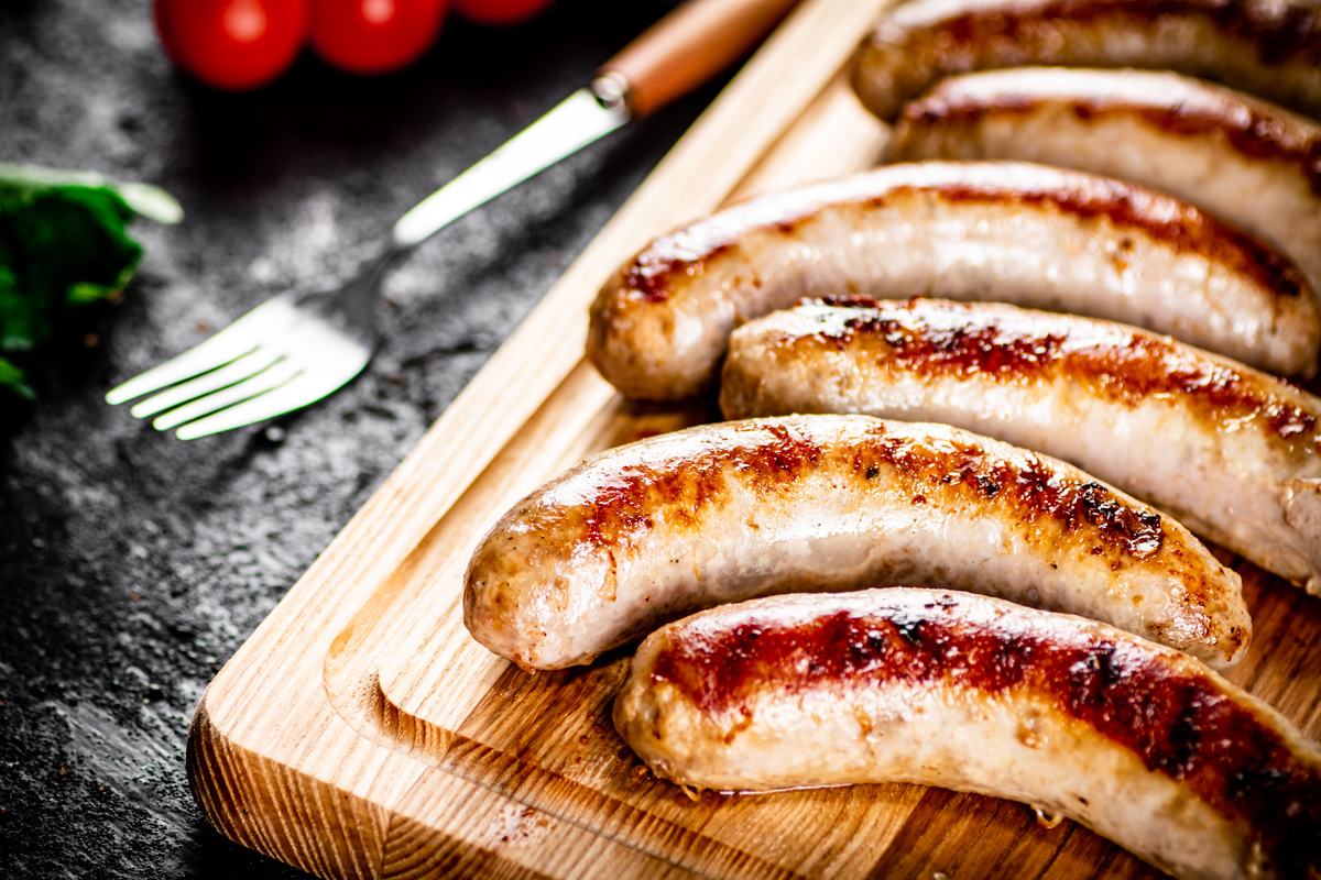 Aromatic Grilled Sausages On A Cutting Board.