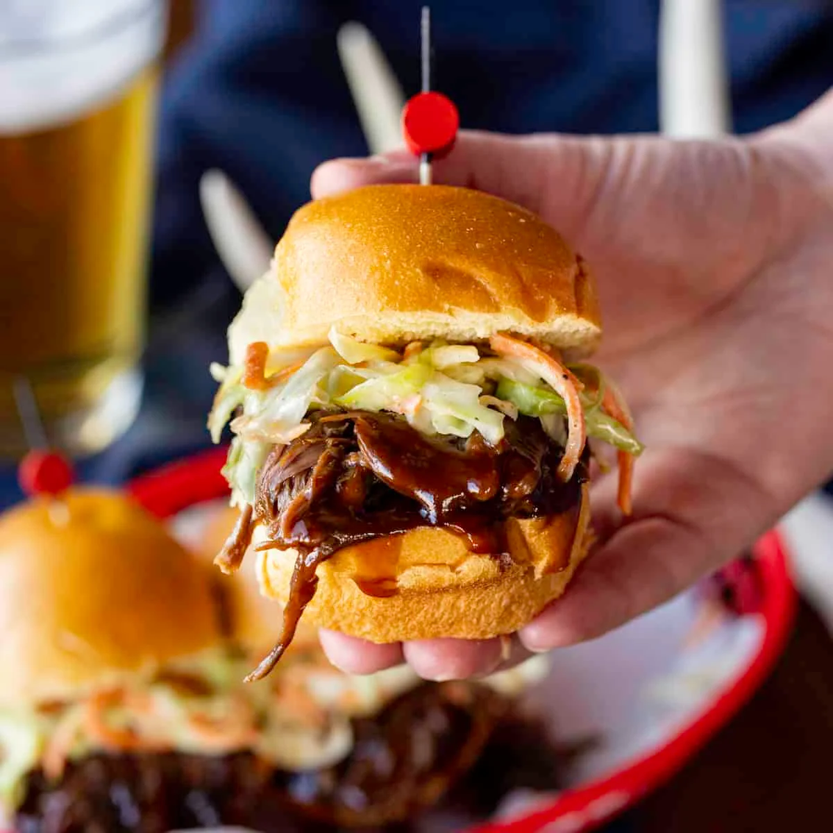 Hand Holding Bbq Venison Slider With Coleslaw 1200×1200 1.jpg